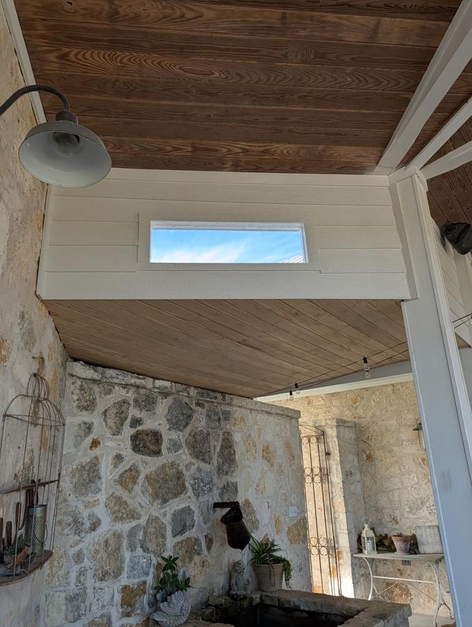 Porch opening closed up with siding and a new window